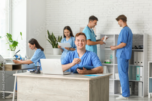 Male doctor with clipboard ...