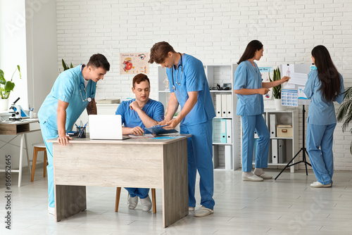 Male doctors working at tab...