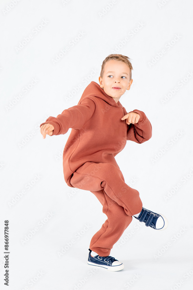 Little Boy in a dancing position. Kid model. A smiling boy on a white background.Portrait of a child. Breakdancing Little Boy in a dancing position. Kid model. A smiling boy on a white background.Portrait of a child. Breakdancing