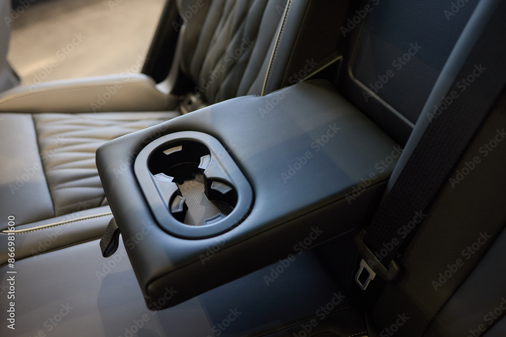 Fototapeta premium Vehicle armrest with cup holder, beige design, for luxury cars