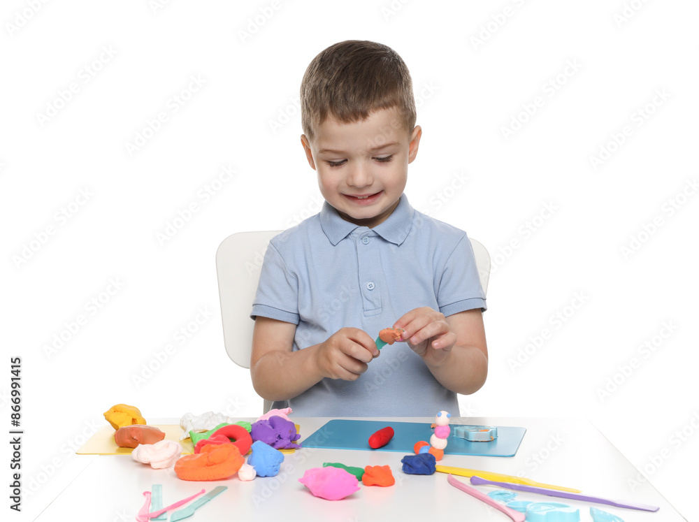 Smiling boy with play dough handiwork at table on white background Smiling boy with play dough handiwork at table on white background