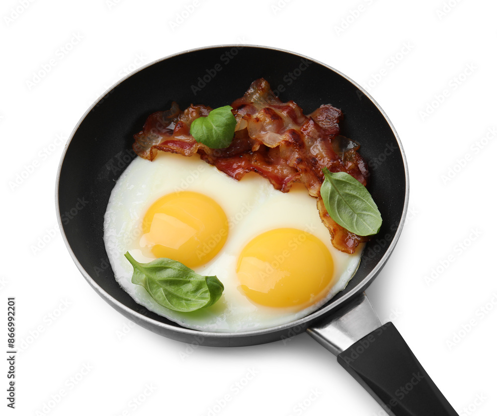 Fried eggs, bacon and basil in frying pan isolated on white Fried eggs, bacon and basil in frying pan isolated on white