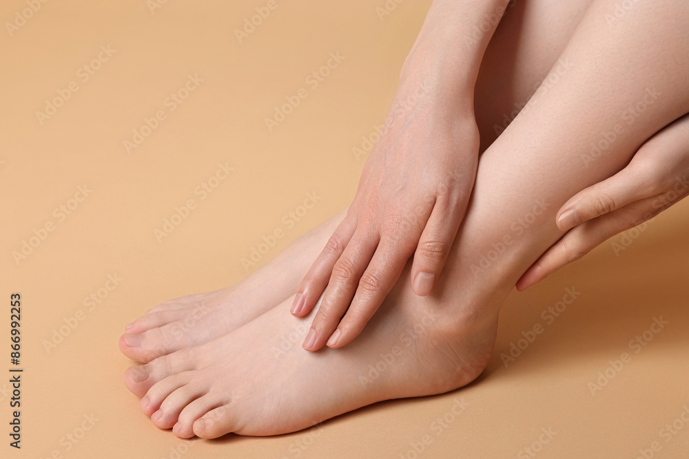 Closeup view of woman`s groomed feet after care procedure on beige background Closeup view of woman`s groomed feet after care procedure on beige background