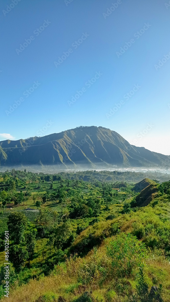 View of Pergasingan Hill from Sembalun village around Mount Rinjani. the landscape is for hiking and outdoor lifestyle concept View of Pergasingan Hill from Sembalun village around Mount Rinjani. the landscape is for hiking and outdoor lifestyle concept