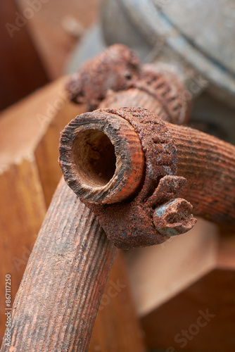 Obraz na plátně old rusty rubber hose clamp in close-up, weathered unusable metal band used in a