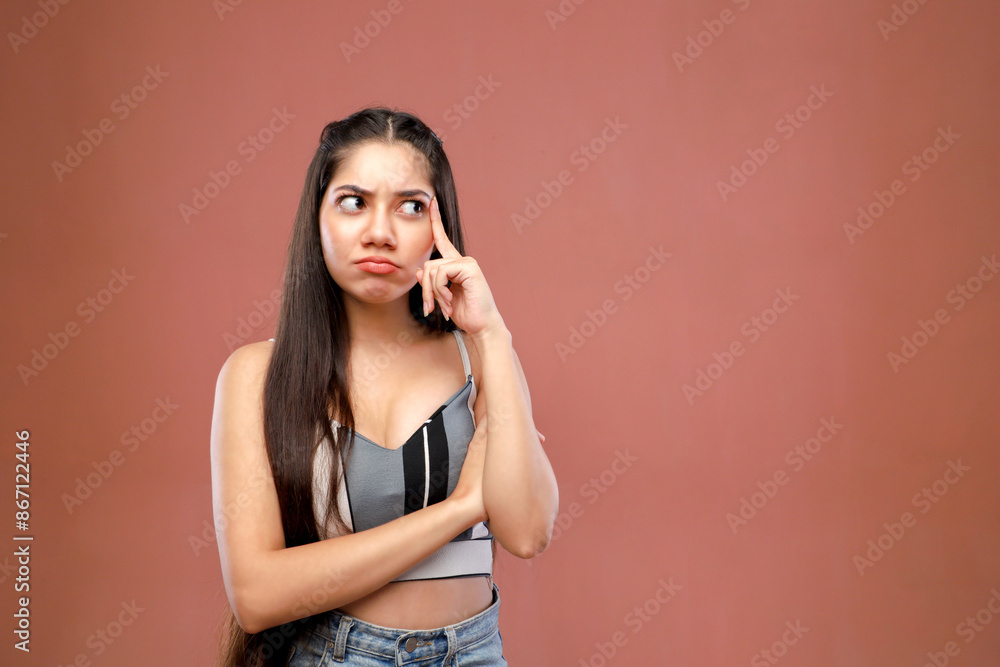 A Sensible Woman Is Thinking While Standing In Front Of A Pink Background A Sensible Woman Is Thinking While Standing In Front Of A Pink Background