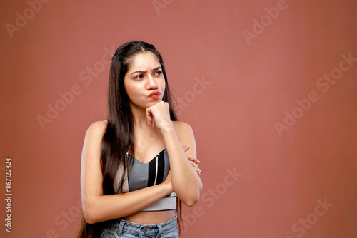 A Critically Thinking Model Posing In Front Of A Pink Background