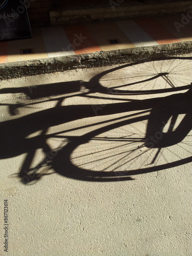 Bicycle shadow on paved road