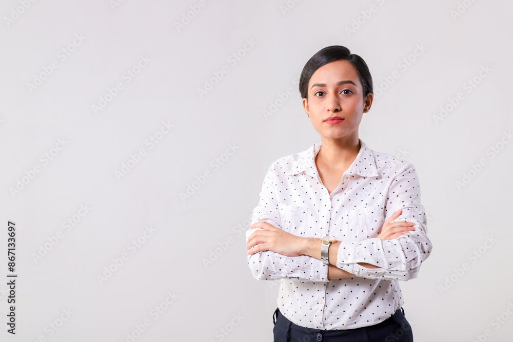 A Stylish Business Woman Standing With Arms Folded Looking At The Camera A Stylish Business Woman Standing With Arms Folded Looking At The Camera