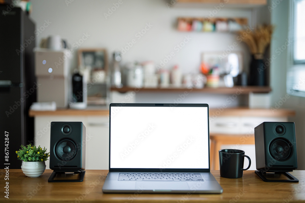 Open laptop with blank screen on a wooden desk in a kitchen room home office Open laptop with blank screen on a wooden desk in a kitchen room home office