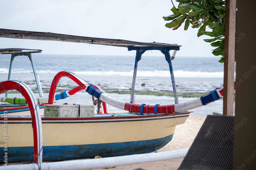 Fototapeta premium Traditional fishing boat docked on a sandy beach