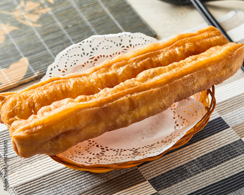 Photography Deep Fried dough sticks served in basket isolated on napkin side view of asian s