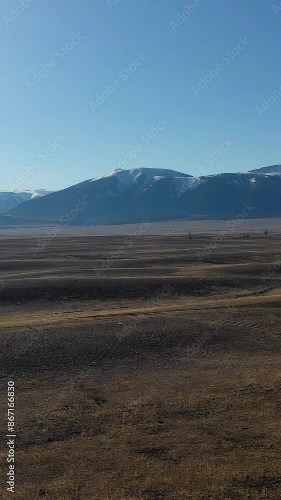 Vertical aerial video panorama from drone of Kurai valley with the Great Ripple in Altai - the bottom of the relict lake. In the background is the Severo-Chuisky mountain range. Vertical aerial video panorama from drone of Kurai valley with the Great Ripple in Altai - the bottom of the relict lake. In the background is the Severo-Chuisky mountain range.