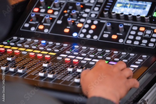 Person Operating Professional Audio Mixing Console photo