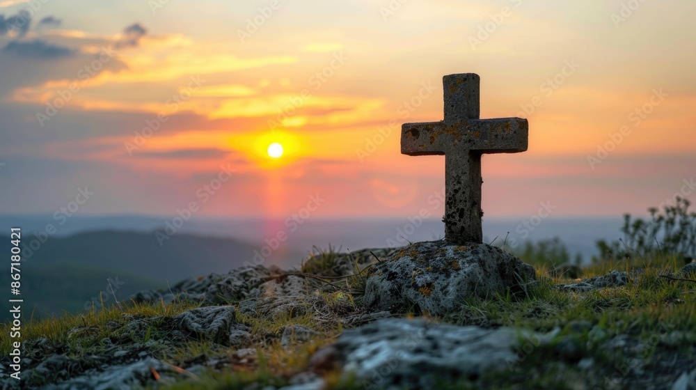 Cross silhouetted on hilltop during sunset Cross silhouetted on hilltop during sunset