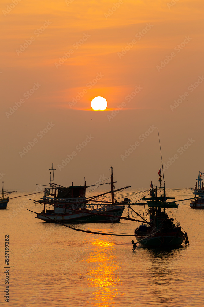 Fototapeta premium Fishing Wood boat on peaceful calm relaxing on the water and dramatic clouds at Sunset