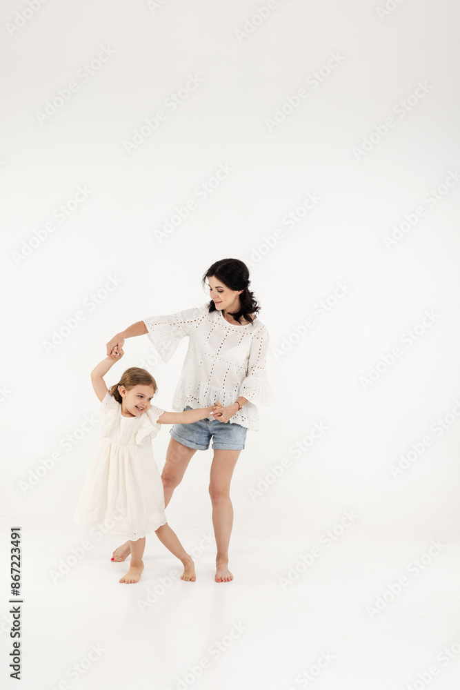 mother in summer clothes has fun with cute little girl. Mother and little daughter isolated on white background. Mother's day, love, family, parenthood, childhood concept. mother in summer clothes has fun with cute little girl. Mother and little daughter isolated on white background. Mother's day, love, family, parenthood, childhood concept.