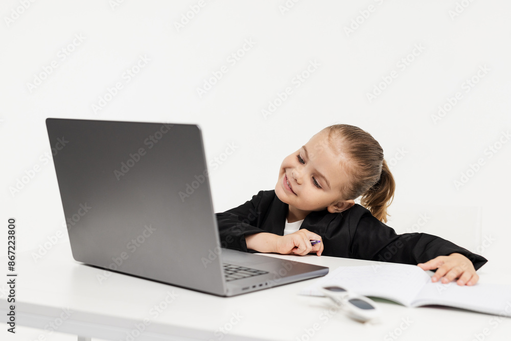 Close-up of a young business girl studying on a laptop on an isolated white background. Concept of modern technology, business and education. Close-up of a young business girl studying on a laptop on an isolated white background. Concept of modern technology, business and education.