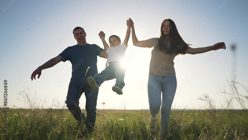 Family enjoying nature sunset. Parents playing game with child. Joyful family in nature. Child swinging between parents. Family bonding at sunset. nature sunset game outdoors. family at play outdoors. Family enjoying nature sunset. Parents playing game with child. Joyful family in nature. Child swinging between parents. Family bonding at sunset. nature sunset game outdoors. family at play outdoors.