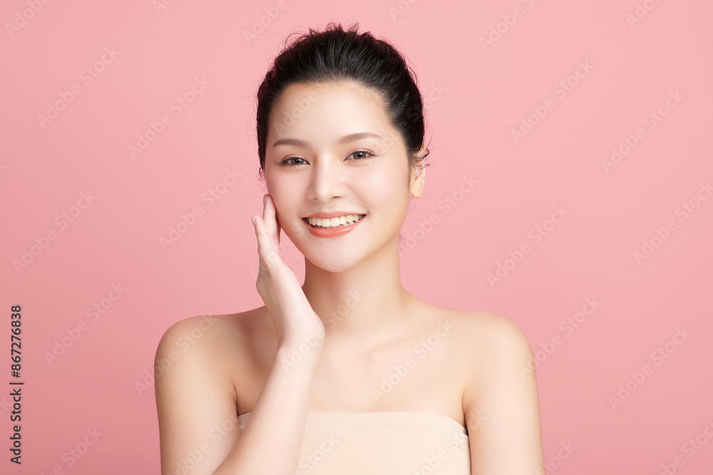 Fototapeta premium Beautiful young asian woman with clean fresh skin on pink background, Face care, Facial treatment, Cosmetology, beauty and spa, Asian women portrait.