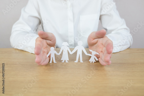 Wallpaper Mural Hand protecting family on wood table. Torontodigital.ca
