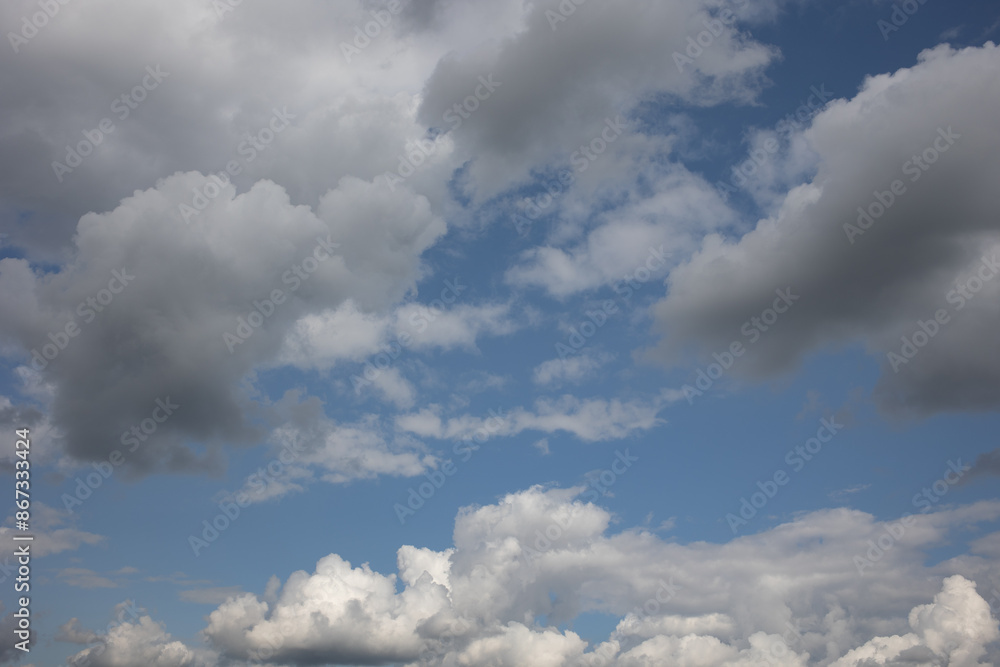 Obraz premium Blue sky. Beautiful Cumulus clouds flying across the sky,