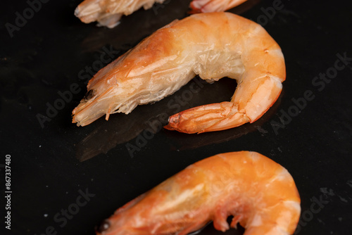 semi-finished product of heavily frozen red shrimps photo