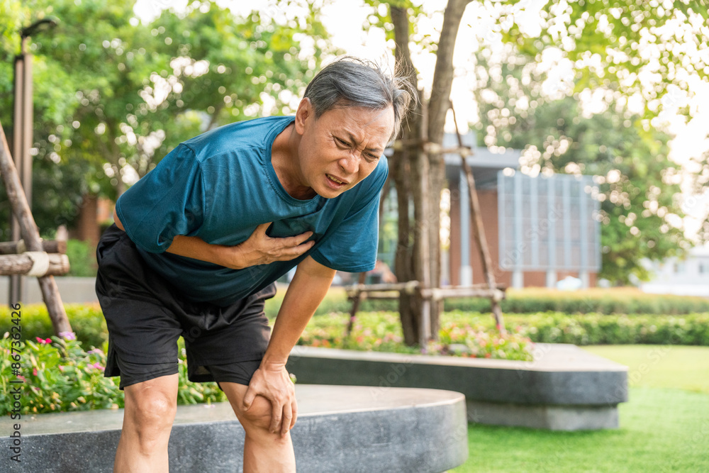 Senior asian man tired during jogging at outdoor nature park. Mature asian male intense training workout challenge breathing exhausted. Healthy and activity lifestyle concept. Senior asian man tired during jogging at outdoor nature park. Mature asian male intense training workout challenge breathing exhausted. Healthy and activity lifestyle concept.