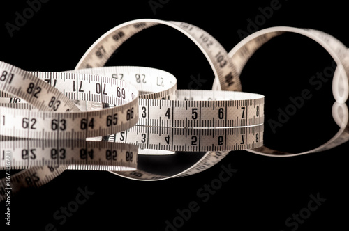 Measuring tape isolated on black with reflection