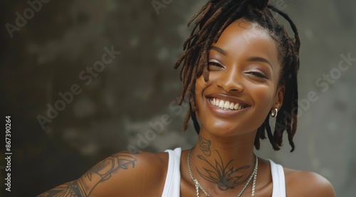 Portrait of a Smiling Woman With Dreads and Tattoos