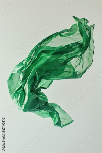 A green plastic bag soaring through the air, suspended by wind currents