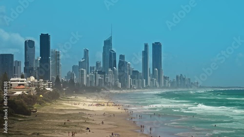4K Footage of Gold Coast Skyline and luxury buildings cityscape with crowd people enjoying at Burleigh Beach from North Burleigh suburbs of the Gold Coast photo