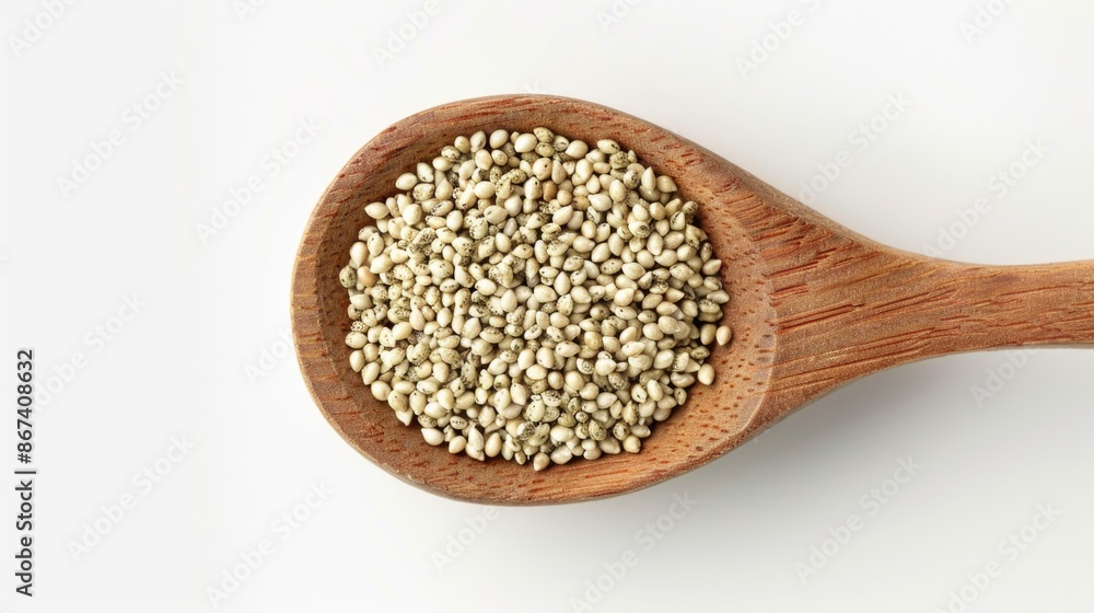 A wooden spoon filled with seeds on a white background A wooden spoon filled with seeds on a white background