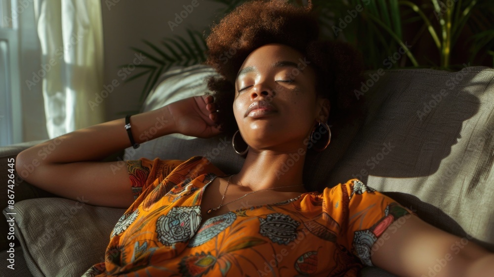 A woman is lying down on a comfortable-looking couch, her eyes are closed A woman is lying down on a comfortable-looking couch, her eyes are closed