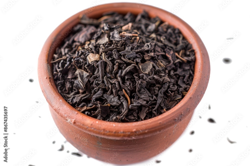 A simple still life scene of a brown bowl filled with black tea leaves, perfect for use in editorial or commercial content related to food, beverage, or lifestyle A simple still life scene of a brown bowl filled with black tea leaves, perfect for use in editorial or commercial content related to food, beverage, or lifestyle