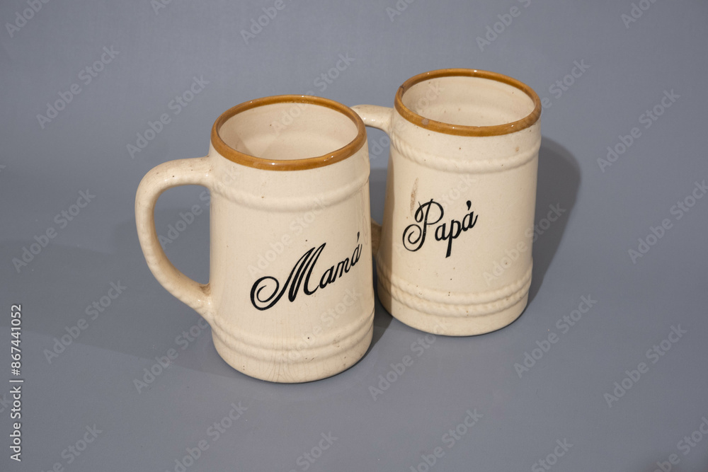 two Ceramic teapot of creamed colour with unique design, kitchen and drinking utencil, isolated on grey background two Ceramic teapot of creamed colour with unique design, kitchen and drinking utencil, isolated on grey background