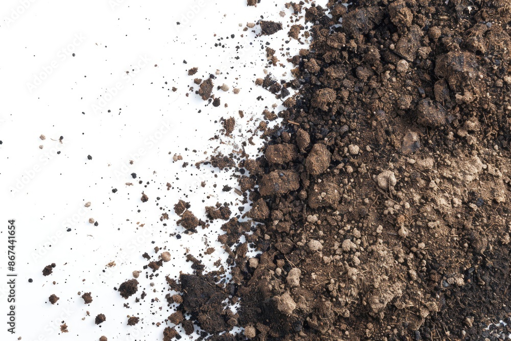 A pile of dirt sitting on a clean white surface, possibly for decoration or display A pile of dirt sitting on a clean white surface, possibly for decoration or display