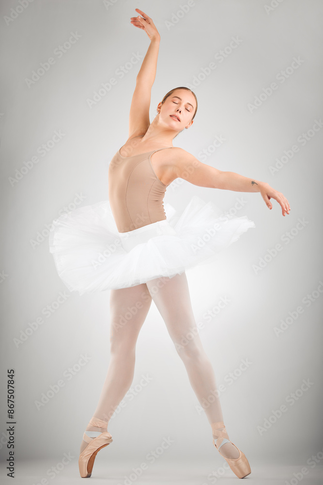 Ballet, dance and ballerina in studio with art career stretching for theater, concert or recital. Creative, pose and woman classical performer with moving for balance practice by gray background. Ballet, dance and ballerina in studio with art career stretching for theater, concert or recital. Creative, pose and woman classical performer with moving for balance practice by gray background.
