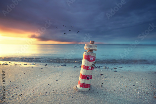 maritime wooden lighthouse at the sunset beach