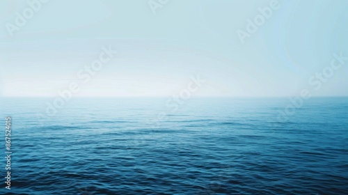 The image features a tranquil ocean with gentle waves under a serene blue sky, offering a peaceful view of the distant horizon with a sense of infinite calmness.