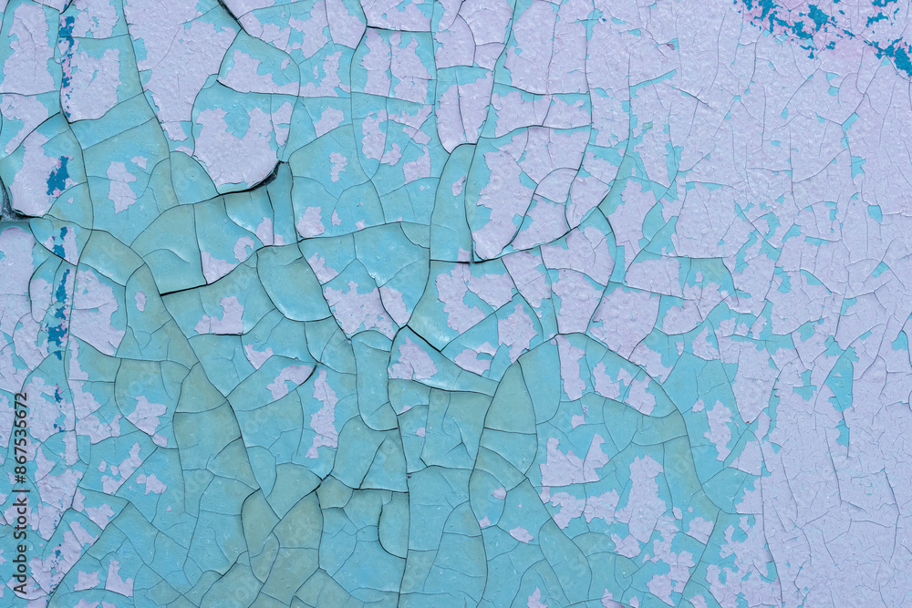 Peeling paint on the wall. Old concrete wall with cracked flaking paint. Weathered rough painted surface with patterns of cracks and peeling. Grunge texture for background and design. High resolution. Peeling paint on the wall. Old concrete wall with cracked flaking paint. Weathered rough painted surface with patterns of cracks and peeling. Grunge texture for background and design. High resolution.