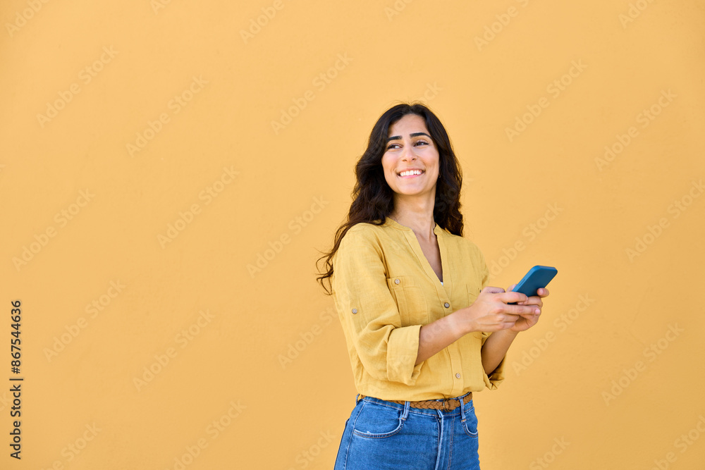 Young middle eastern brunette woman in casual clothes using mobile cellphone app for communication, shopping, buying, trade online. Smiling arabian girl holding smartphone phone, looking at copy space Young middle eastern brunette woman in casual clothes using mobile cellphone app for communication, shopping, buying, trade online. Smiling arabian girl holding smartphone phone, looking at copy space