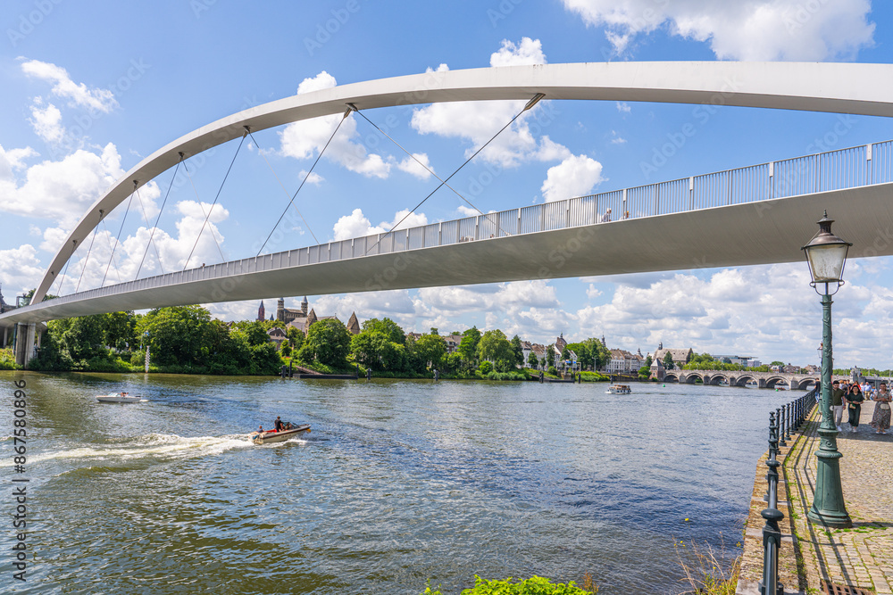 Φωτογραφία Maastricht, The Netherlands - June 23 2024 - People crossing the Maas river on the High Bridge (Hoge Brug) and get into the center of town