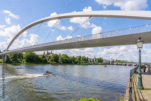 Maastricht, The Netherlands - June 23 2024 - People crossing the Maas river on the High Bridge (Hoge Brug) and get into the center of town. Seen from the river side
