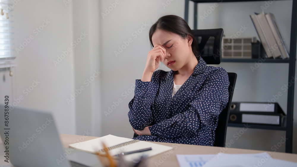 Businesswoman feeling exhausted and stressed from overworked while resting in modern office after working to analysis about investment of business project and strategy marketing of new business Businesswoman feeling exhausted and stressed from overworked while resting in modern office after working to analysis about investment of business project and strategy marketing of new business