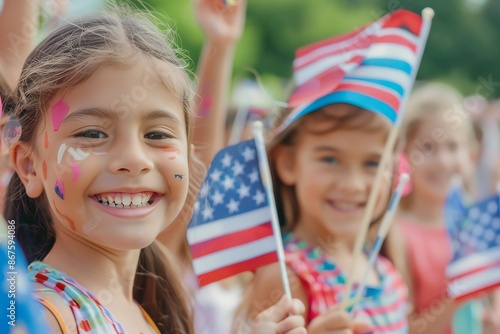 Smiling girls with face paint and American flags celebrate a patriotic event.