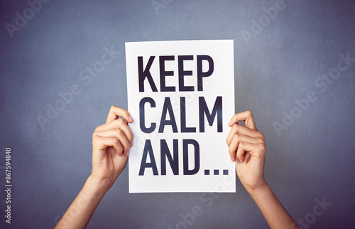 Poster, text and hands in studio with keep calm message, announcement and reminder against grey background. Mockup, word and letter banner with relax quote, inspiration and card, person or ad paper