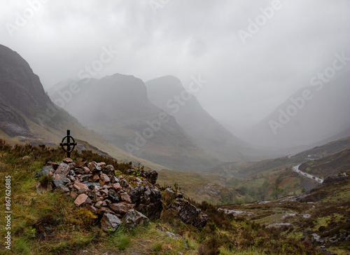 Ralston memorial viewpoint, valley of Glencoe, Scotland, with road and foggy mountains in background