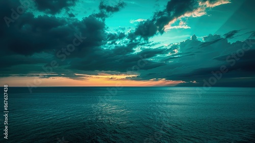 Fototapeta Naklejka Na Ścianę i Meble -  As the sun sets on the Black Sea, the sky transforms into a dramatic canvas of teal and azure, contrasting sharply with the dark, tranquil sea.