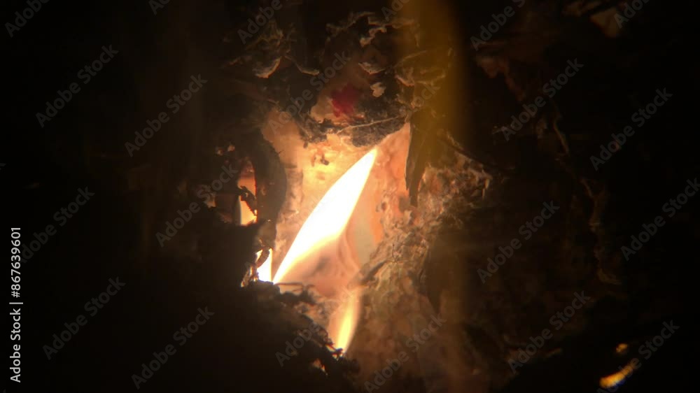 Yellow flames burning in a pile of rubbish at night Yellow flames burning in a pile of rubbish at night